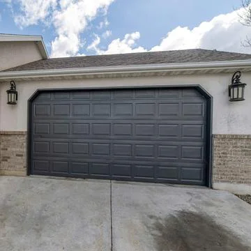 Square White puffy clouds Clipped corner black sectional garage door exterior Fotos de archivo
