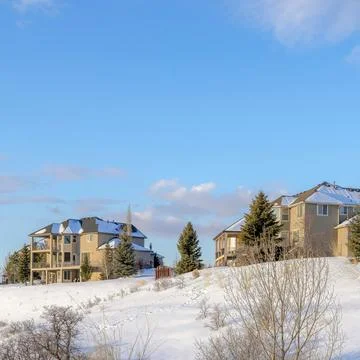 Square White puffy clouds Large residential area on top of a snowy hill at Stock Photos