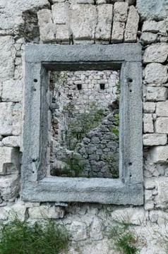 Square window in a stoney wall of old ruins in Slovenia Stock Photos