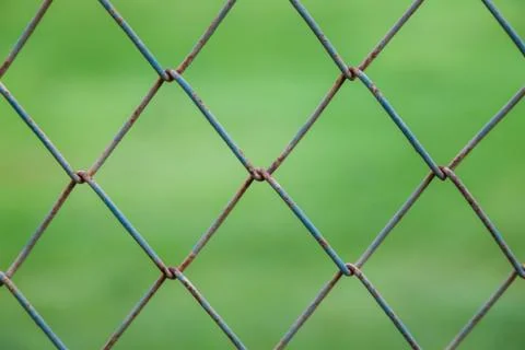 Square wire wall with blurry green background Stock Photos