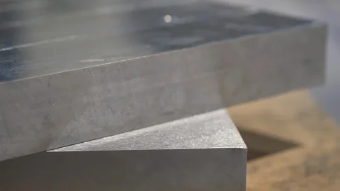 Squared aluminum block before processing in the workshop. Video stock 126670982