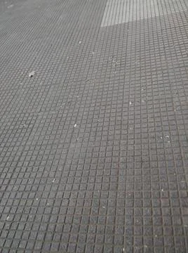 Squared concrete background with different elements in street in daylight Stock Photos