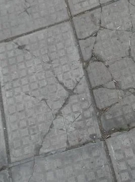 Squared sidewalk concrete gray background with different elements in street i Foto stock