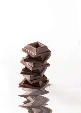 Squares of chocolate on white background Stock Photos