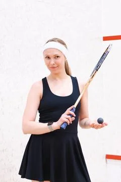 Squash Player Holding Racket and Ball Indoors Stock Photos
