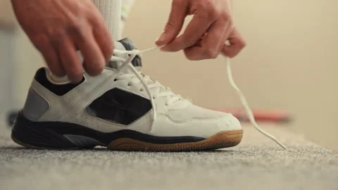 Squash player tying his shoe Stock Footage 278978253