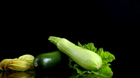 Squash vegetable with vibrant blossom on dark reflective background Stock Footage 340415855