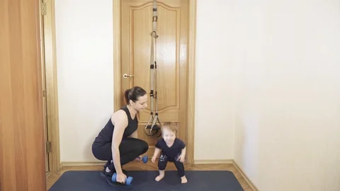 Squatting with a child Stock-Footage 129556126