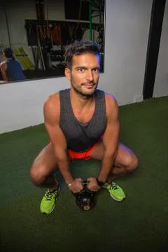 Squatting with a kettlebell Foto stock