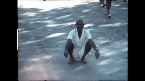 Squatting Man in White Clothes Stock Footage 277976232