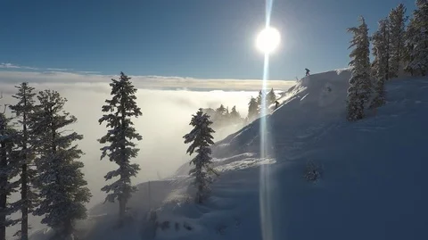 Squaw Valley Sunrise above the fog skier and snowboarder drop in Stock Footage