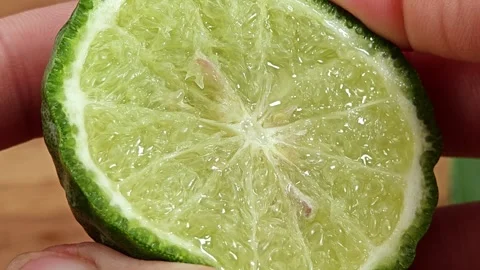Squeeze fresh kaffir lime by hand. Stock Footage 310249480