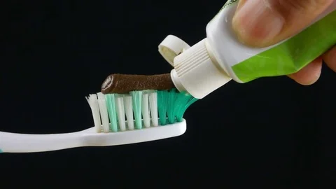 Squeeze herbal toothpaste with black on the toothbrush. Stock Footage 84507359