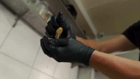 Squeeze the juice out of the half lemon by hand. Lemon juice drains from th.. Stock Footage 265839058