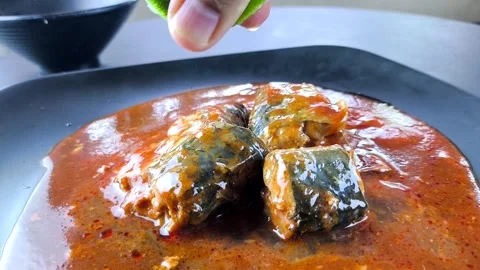 Squeeze a lemon on canned fish Stock Footage 318143061