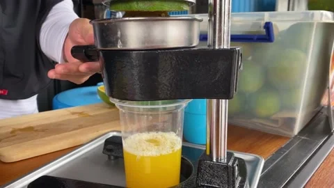 Squeeze oranges using a hand juicer Stock Footage 221401086