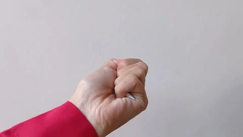 Squeeze a paper with left hand and white background Stock Footage 145562829