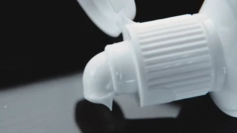 Squeeze a paste-like white opaque cream out of a plastic tube. Extreme close-up Stock Footage 151355290