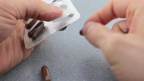Squeeze pills close-up.Nervous squeezing pills.Medication addiction. Stock Footage 195299501