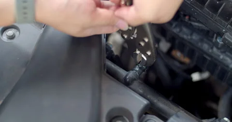 Squeeze the Spring clamp to lock the car water hose and put it back in place. Stock Footage 310912201
