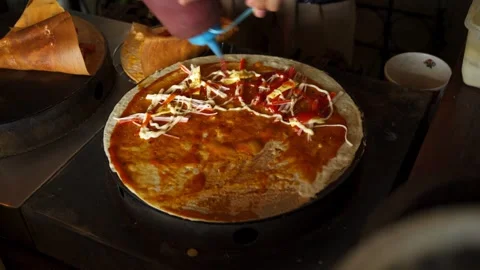 Squeeze tomatoes sauce onto the pizza crispy crepe on the crepe stove Stock Footage 278571180