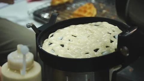 Squeeze the waffle batter onto the baking oven. How to make honeycomb waffles. Stock Footage 246503040