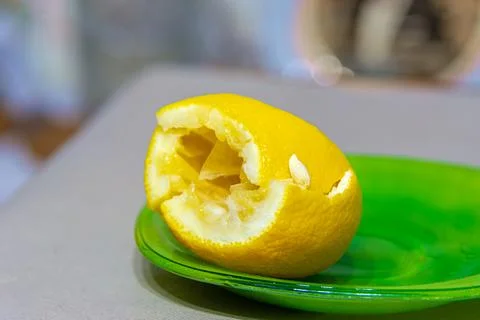 Squeezed lemon on a green plate Stock Photos