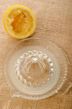 Squeezed lemon, lemon squeezer and fresh lemon juice Stock Photos