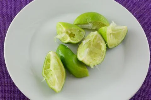 Squeezed lime fruit wedges Stock Photos