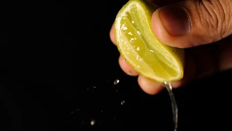 Squeezed lime in slow motion. Lime on black background Stock Footage 125223609