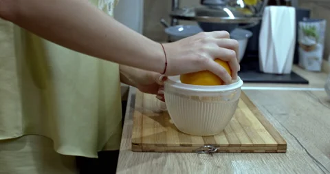 A squeezed orange to prepare a fresh juice. Slow motion. Stock Footage 145791398