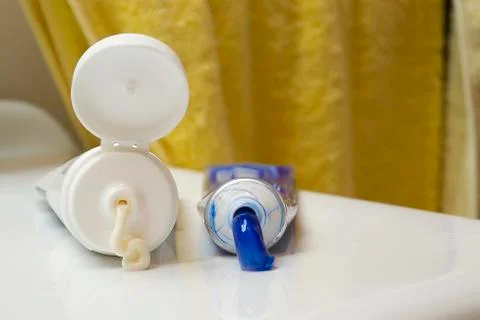 Squeezed tubes on sink Stock Photos