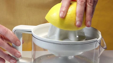 Squeezer a grapefruit with an electric citrus squeezer Stock Footage 8573758