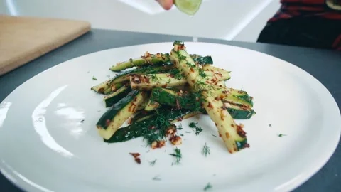 Squeezes lime on sliced and spiced cucumber. Healthy food. Beautiful serving Video stock 133246630