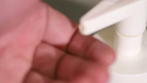 Squeezes liquid soap. close-up Stock Footage 121496837