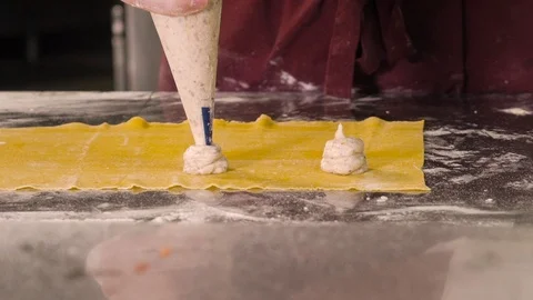 Squeezes the stuffing on the dough Video stock 107891339