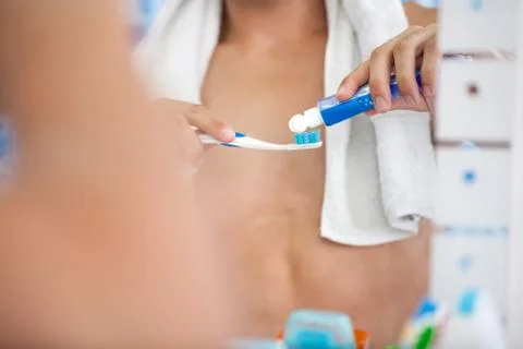 Squeezes toothpaste on the brush Stock Photos