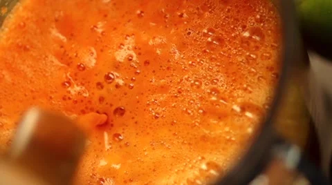 Squeezing carrot juice in slow motion Stock Footage 54558939