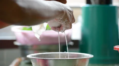 Squeezing coconut milk Stock Footage 26555250