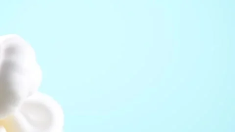 Squeezing foam from the bottle on a blue background. Video stock 284222442