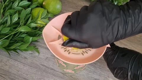 Squeezing Fresh Lime Juice with Hand Juicer | Healthy Drink Preparation Stock Footage 345025154
