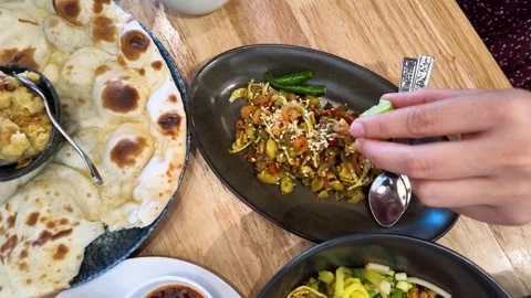 Squeezing Fresh Lime Juice Over Burmese Tea Leaf Salad Dish Stock Footage 345102033