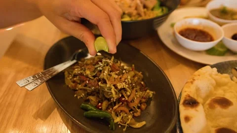 Squeezing Fresh Lime Juice Over Burmese Tea Leaf Salad Stock Footage 345463967