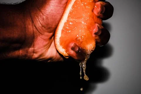 Squeezing a Fresh Orange Background Stock Photos