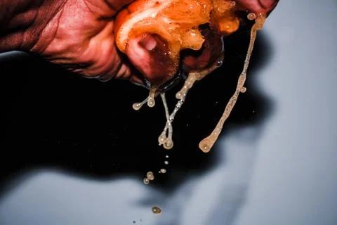 Squeezing a Fresh Orange Background Stock Photos