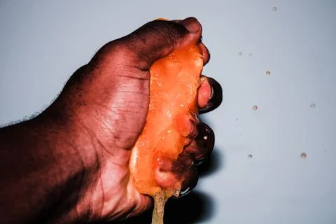 Squeezing a Fresh Orange Background Stock Photos