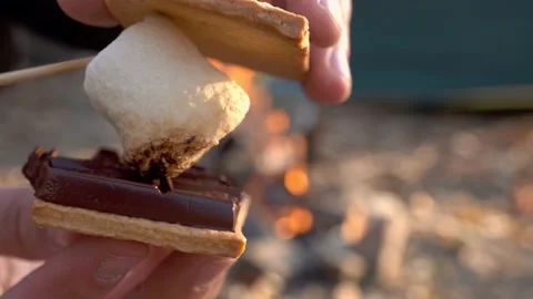 Squeezing fried marshmallows between crackers with chocolate. Smor. Stock Footage 146682324