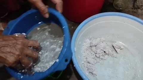 Squeezing grated coconut the traditional way Stock Footage 219215726