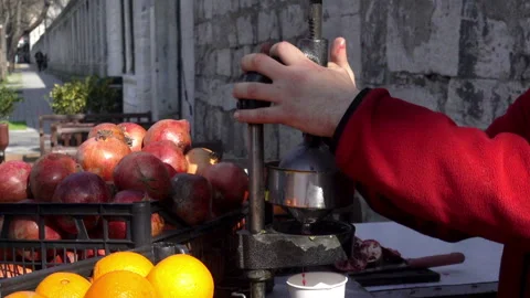 Squeezing the juice from fresh pomegranate fruit. Stock Footage 101951424
