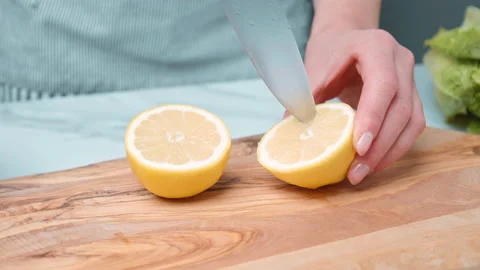 Squeezing the juice from a lemon in a Caesar Salad Sauce in 4K. Stock Footage 140767048
